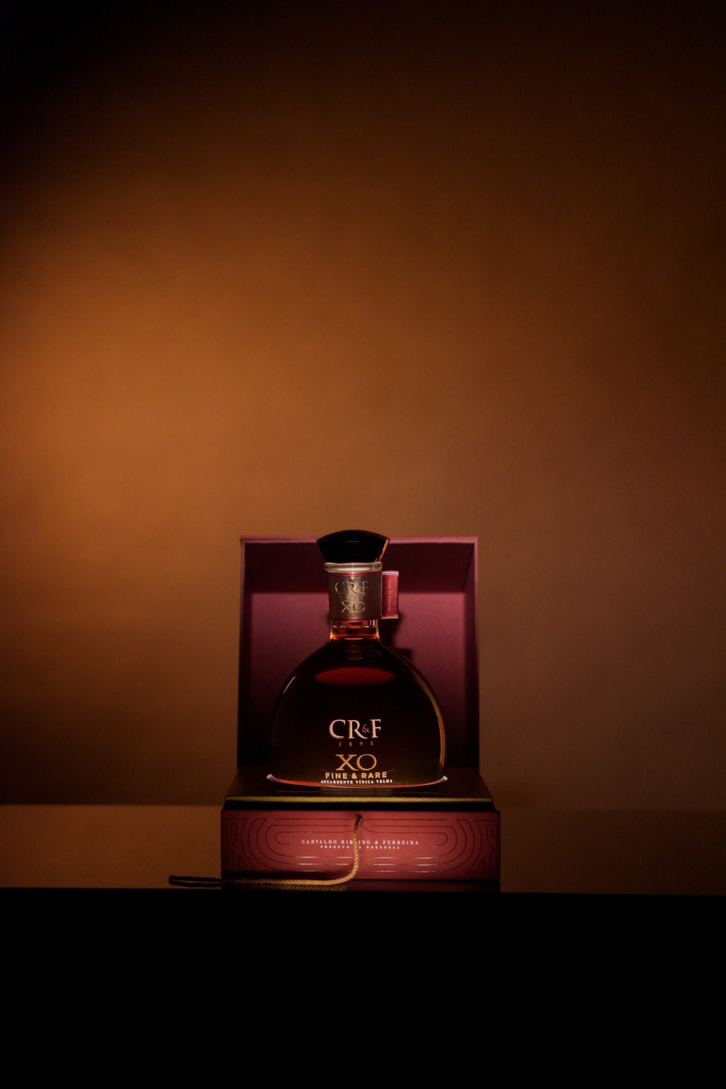  Luxurious CR&F XO Fine & Rare brandy showcased in an elegant box with warm lighting and a refined presentation.