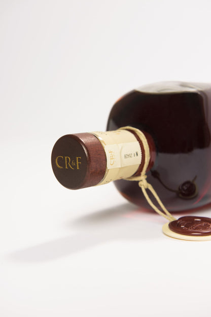 Vínica Velha CR&F Reserva Extra brandy lying down, showing the wooden cork, seal, and label details.